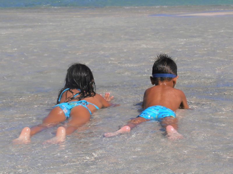 Elafonissi beach kids lying in the lagoon