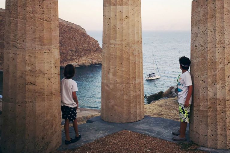 Two kids standing next to ancient Karthea ruins