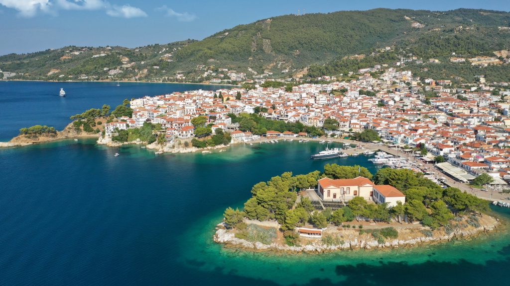 Aerial drone photo of amazing vegetated islet of Bourtzi built in small peninsula in port of Skiathos island main town hosting an old school, Sporades, Greece SH-min