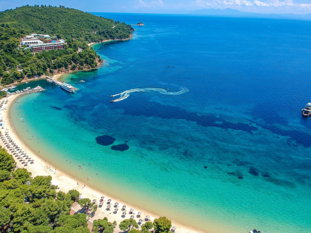 Aerial view over Koukounaries beach in Skiathos island, Sporades, Magnesia, Greece SH-min